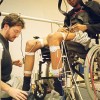 Biomedical engineer Dr Adam Thrasher attaches electrodes to the legs of paraplegic Raymond Daniel, who hopes to regain the use of his legs through 'functional electrical stimulation. Published in The Varsity, November 17 2003.